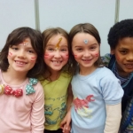 This is an image of kids on an african yoga adventure with face paint.