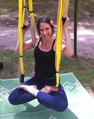 This is an image of Michaela doing aerial yoga lotus pose at Prana festival, Coromandel.