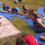 Children saying namaste in kids yoga class.
