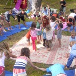 This is an image of children creating a group hibiscus yoga flower.